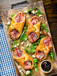 Overhead cheddar cheese and streaky bacon turnovers with Branston pickle.