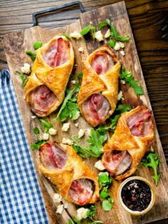 Overhead cheddar cheese and streaky bacon turnovers with Branston pickle.