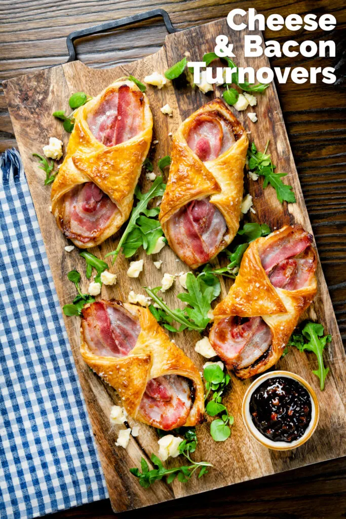 Overhead cheddar cheese and streaky bacon turnovers with Branston pickle featuring a title overlay.