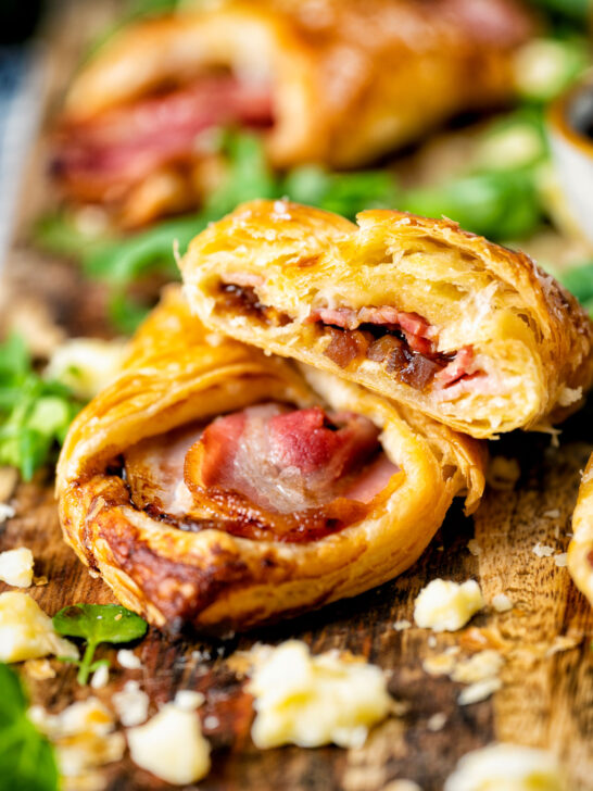 Cheese and bacon turnover with Branston pickle cut in half to show texture.