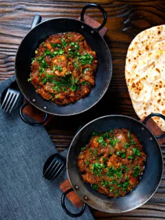 Overhead Anglo Indian chicken dopiaza curry served with chapatis.