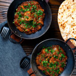 Overhead Anglo Indian chicken dopiaza curry served with chapatis featuring a title overlay.