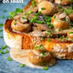 Close-up creamy garlic mushrooms on toast with snipped chives featuring a title overlay.