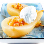 Dessert wine poached pears with golden raisins and Chantilly cream.
