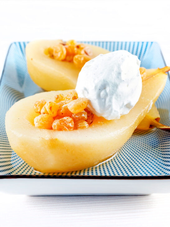 Dessert wine poached pears with golden raisins and Chantilly cream.