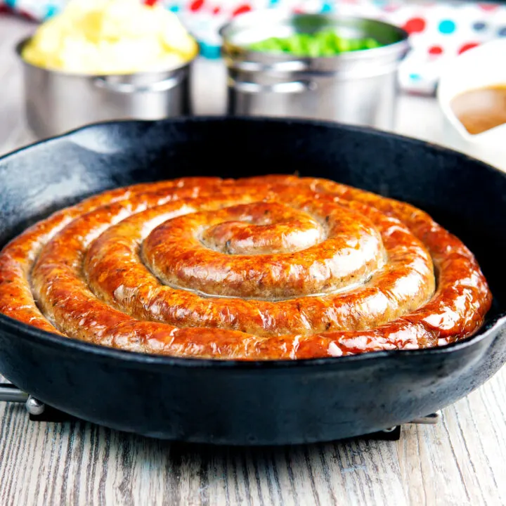 Homemade Cumberland sausage ring roasted in a cast iron pan, with gravy peas and mash.