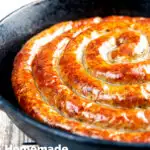 Close up cooked Cumberland sausage ring in a cast iron pan featuring a title overlay.