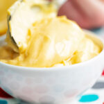 Thick and creamy golden mayonnaise in a bowl.