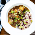 Overhead Jamaican curry goat served with rice and peas.