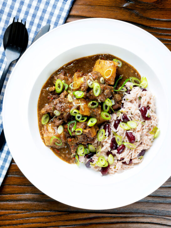 Overhead Jamaican curry goat served with rice and peas.