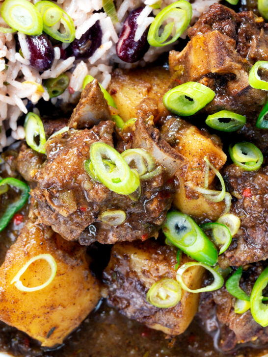 Overhead close-up Jamaican goat curry served with rice and peas.