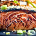 Close-up Korean inspired grilled salmon fillet served with noodles featuring a title overlay.