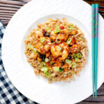 Overhead kung po king prawns with peanuts and egg fried rice featuring a title overlay.