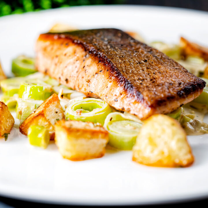 Pan fried salmon fillet with crispy skin served with creamed leeks and Parmentier potatoes.