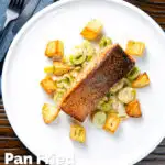 Overhead pan fried salmon fillet served with creamed leeks and parmentier potatoes featuring a title overlay.