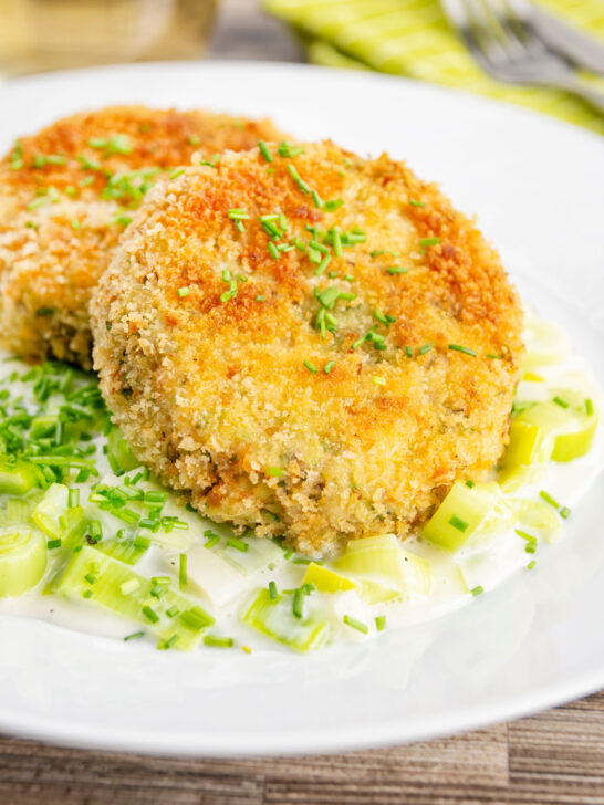 Crispy golden salmon and sardine fish cakes served with creamed leeks.