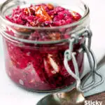 Sticky red cabbage chutney in a storage jar featuring a title overlay.