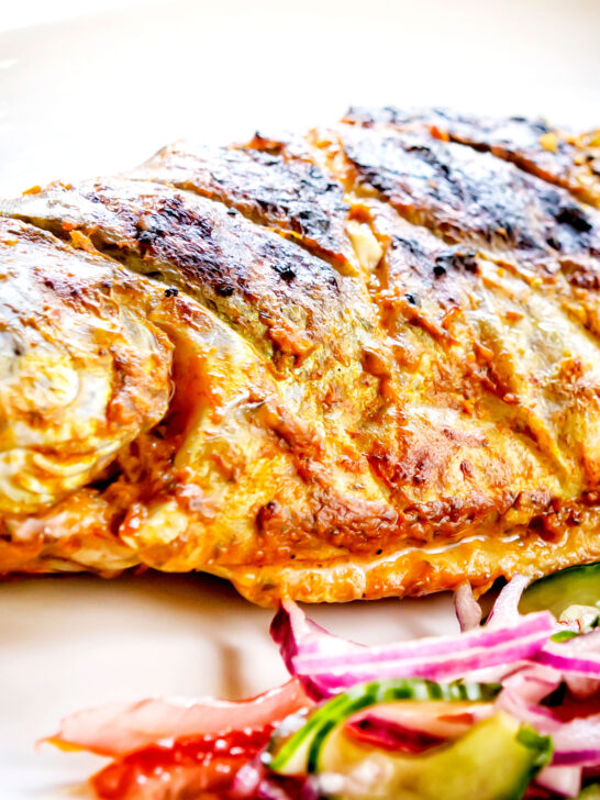 Close-up tandoori trout fish that has been cooked on a BBQ.