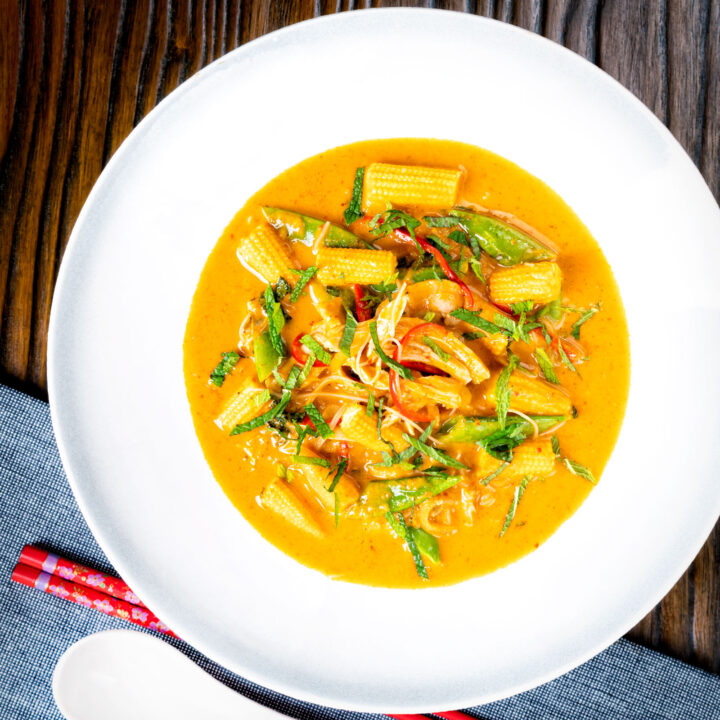 Thai red curry chicken noodle soup with sugar snap peas and baby sweet corn.