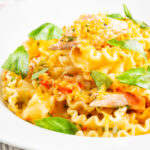 Tomato and salmon fillet pasta with basil and crispy bread crumbs.