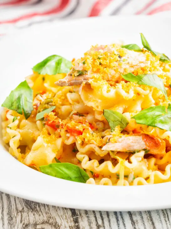 Tomato and salmon fillet pasta with basil and crispy bread crumbs.