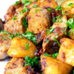 Close-up Hungarian Brassói aprópecsenye with crispy potatoes, bacon and pork tenderloin.