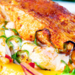 Close-up air fryer stuffed chicken breast with mozzarella cheese and jalapeno chilli peppers.