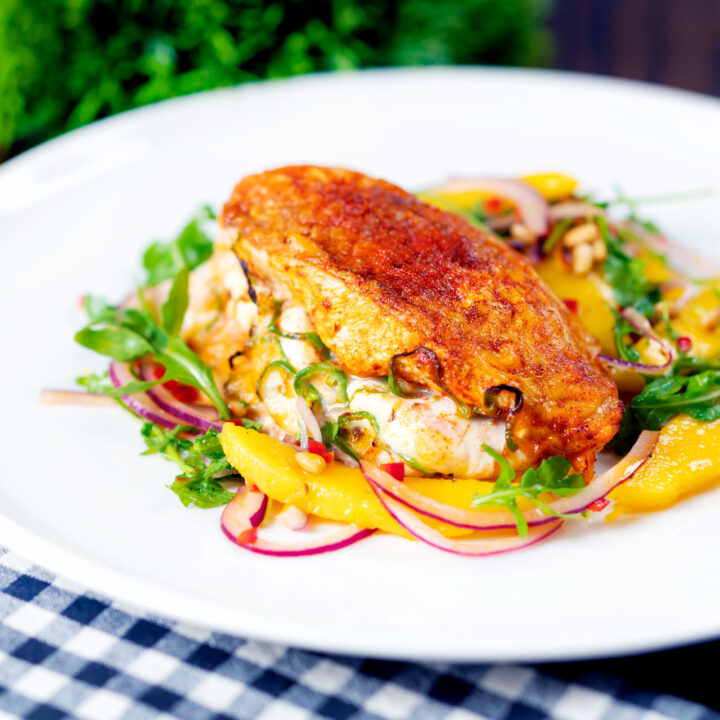 Air fryer stuffed chicken breast with mozzarella cheese and jalapeno peppers served with mango salad.
