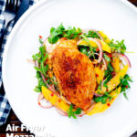 Overhead air fryer stuffed chicken breast with buffalo mozzarella cheese and jalapeno chilli peppers featuring a title overlay.