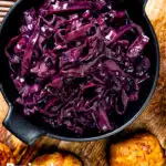 Overhead braised red cabbage with red wine and brown sugar featuring a title overlay.