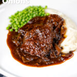 Braised steak and onions served with mashed potato and peas featuring a title overlay.