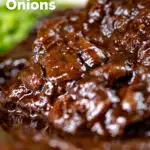 Close-up braised steak and onions served with mashed potato and peas featuring a title overlay.