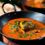 Chicken chasni curry served with naan bread featuring a title overlay.