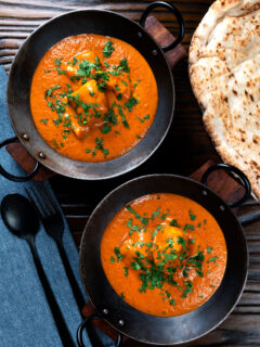 Overhead chicken chasni curry served with naan bread.