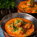 Indian chicken kofta or meatball curry served in an iron karai.