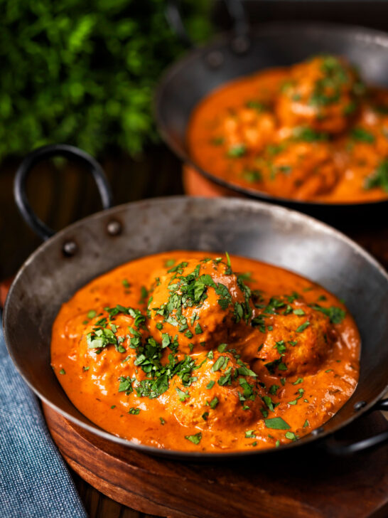 Indian chicken kofta or meatball curry served in an iron karai.