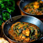 Indian inspired chicken saag or saagwala curry served with naan bread.