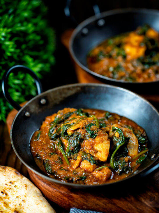 Indian inspired chicken saag or saagwala curry served with naan bread.