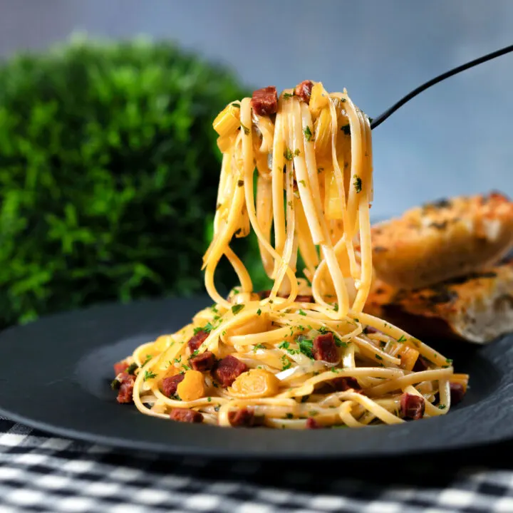 Spanish chorizo is sausage and shredded leek pasta served with garlic bread.