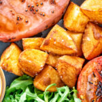 Crispy fried or sauteed potatoes served with bacon chop, grilled tomato and rocket.