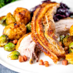 Slow roasted crispy pork belly Sunday lunch, with red cabbage, sprouts and roast potatoes.