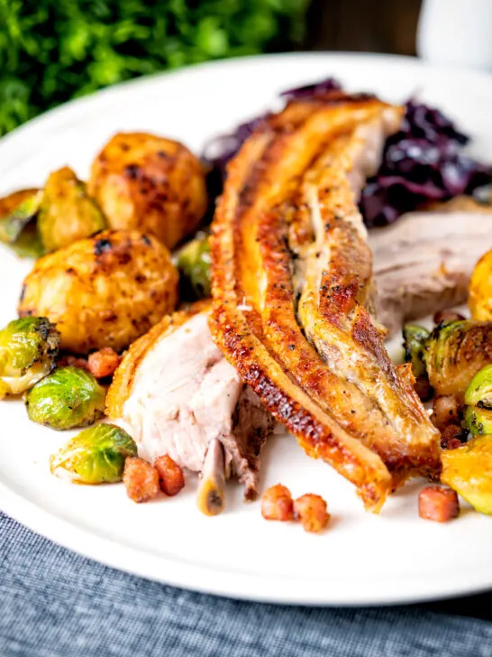 Slow roasted crispy pork belly Sunday lunch, with red cabbage, sprouts and roast potatoes.