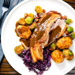 Overhead slowly roasted pork belly, roast potatoes, sprouts, red cabbage and cider gravy.