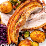 Overhead slow roast pork belly, roast potatoes, miso sprouts and red cabbage featuring a title overlay.