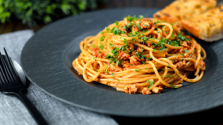 Vegan crumbled tofu pasta in a spiced tomato sauce.