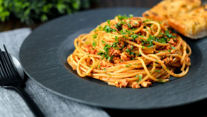 Vegan crumbled tofu pasta in a spiced tomato sauce.