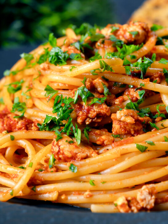 Close-up crumbled tofu pasta in a spiced tomato sauce.