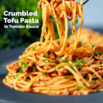 Crumbled tofu pasta in a spiced tomato sauce being picked up with a fork, featuring a title overlay.