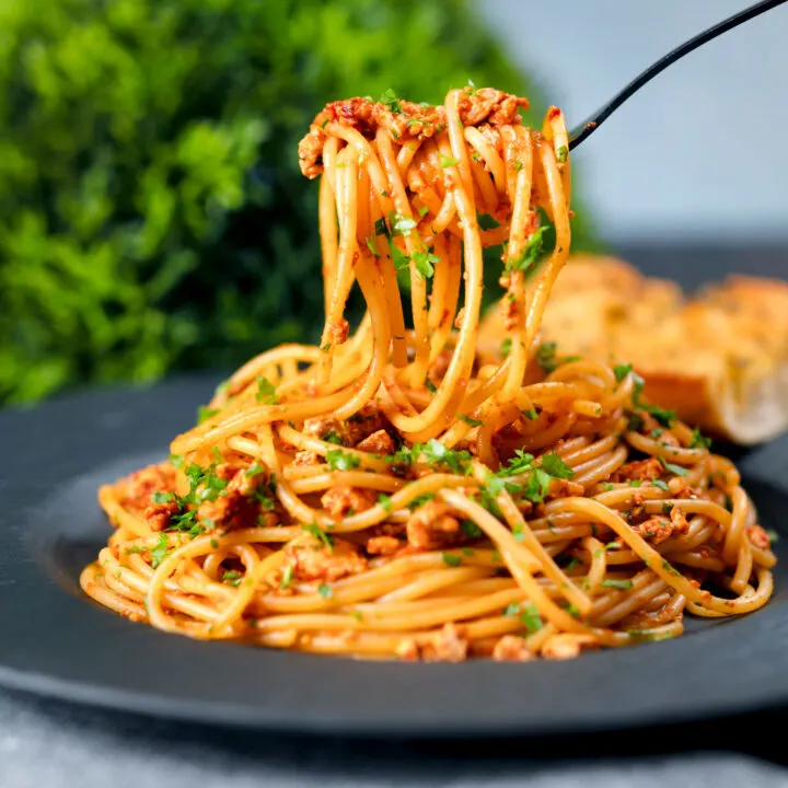 Vegan crumbled tofu pasta in a spiced tomato sauce.