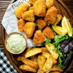 Overhead fish goujons or nuggets made with monkfish served with tartar sauce and wedges.